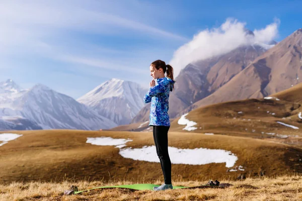 Жінка робить ранкові вправи на фоні гір — стокове фото