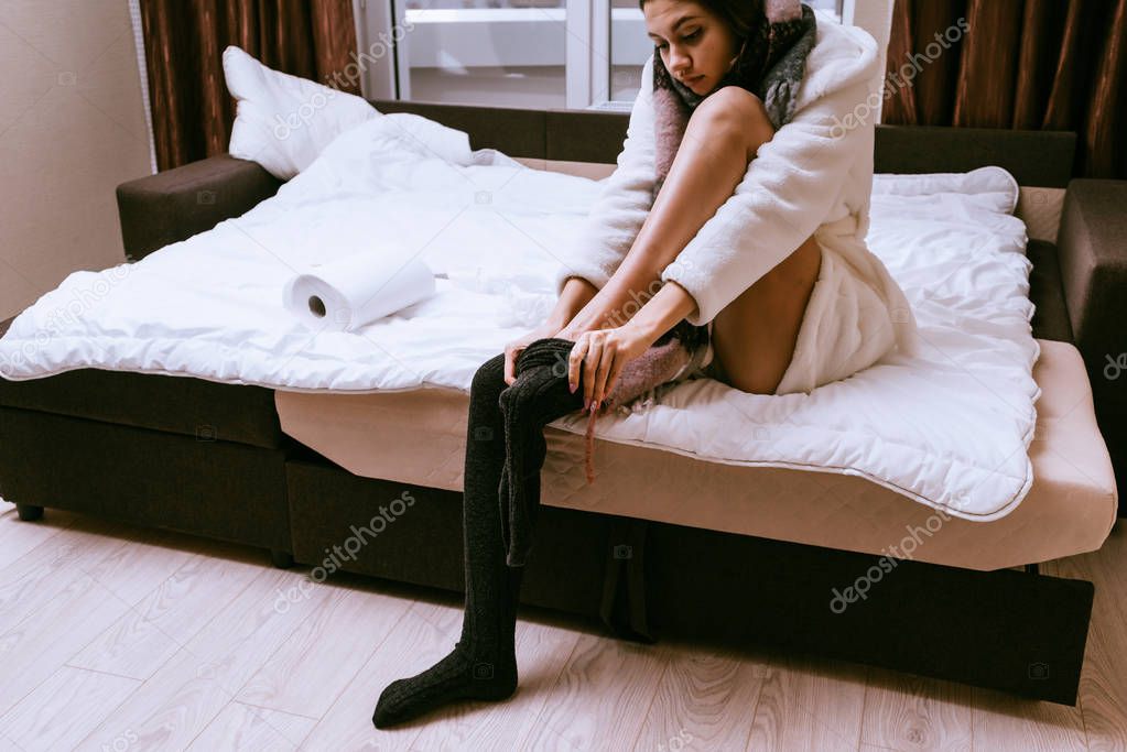 woman dresses sitting in bed in the morning