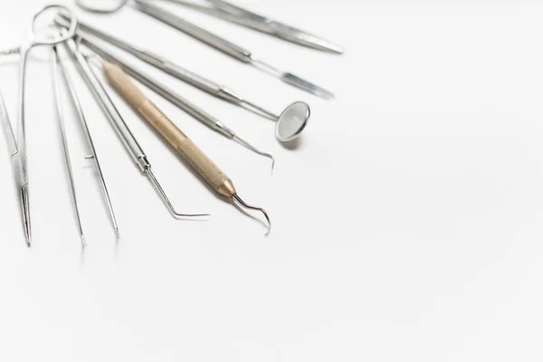 On a white background lies a sterile dental toolkit — Stock Photo, Image
