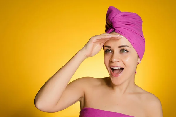 Ευτυχισμένη γυναίκα με μια πετσέτα στο κεφάλι της σε κίτρινο φόντο — Φωτογραφία Αρχείου