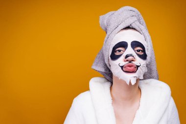 bir kadının kafasındaki bir havlu ile geçerli bir panda bir namlu şeklinde nemlendirici maske