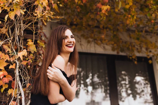 happy rich woman on a background of autumn nature