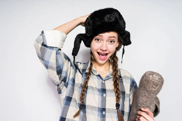 Happy Russian beauty in a hat with a fur hat Stock Picture