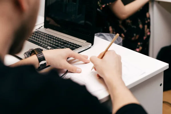 Un uomo siede sulla formazione e ciò che scrive — Foto Stock