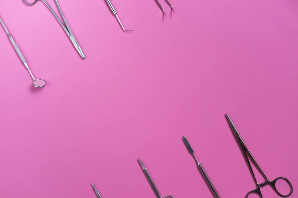 On the pink surface are medical dental instruments — Stock Photo, Image