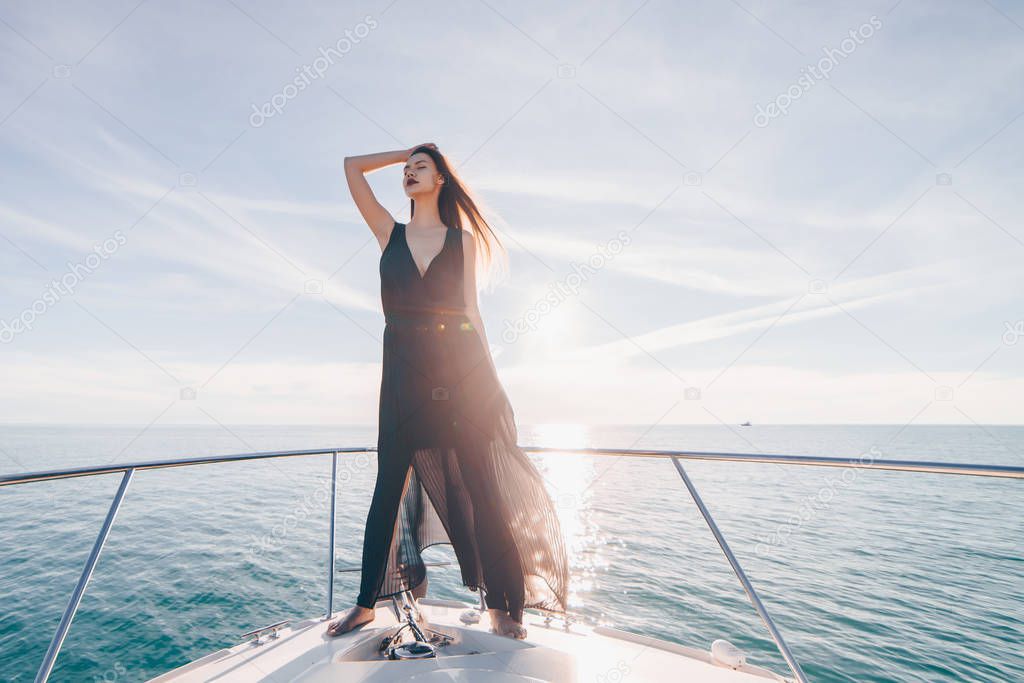 a luxurious long-haired girl is standing on a big white yacht, enjoying sea voyage