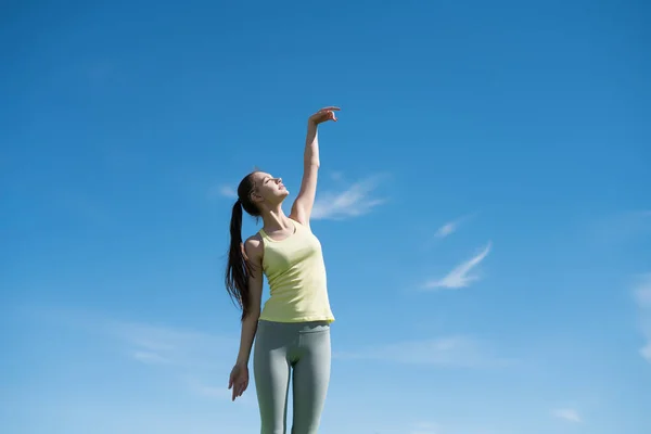 Harmonické, klidné dívka zabývající se jógu pod modrou oblohou, medituje a uvolňuje — Stock fotografie