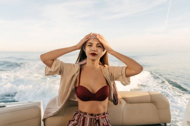 Kameraya bakarak şık genç bayanlar yaz giysileri Karayip Denizi üzerinde bir yatta yelken