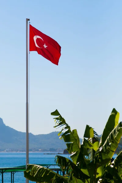 Turkish Flag Flagpole Fluttering Wind Sea Mountains Palm Trees — Stock Photo, Image