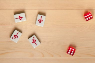 Kırmızı zar ve kemiklere mahjong hafif kahverengi ahşap arka plan üzerinde (kiremit).