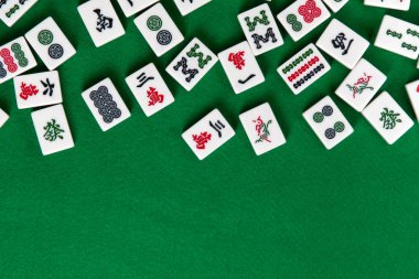 White-green tiles for mahjong on on green cloth background. Emty space from below clipart