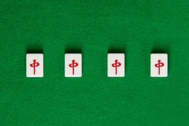 White-green tiles for mahjong on green cloth. 4 dragons clipart