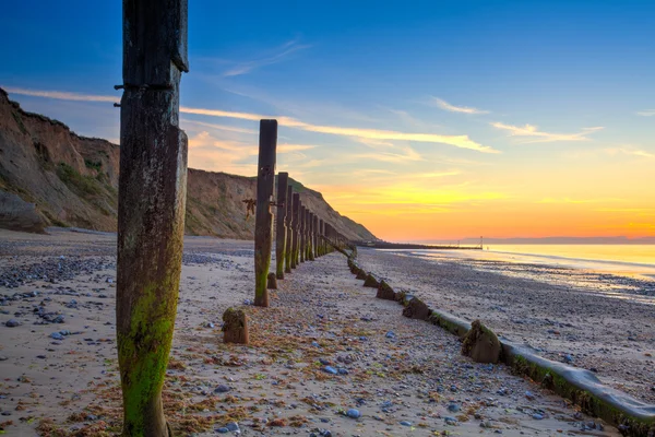 Sheringham beach and cliffs at sunset,,, England — стоковое фото