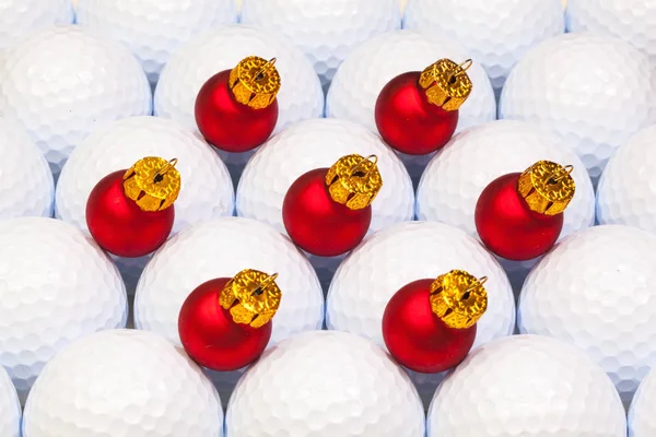 Red Christmas decoration between the golf balls — Stock Photo, Image