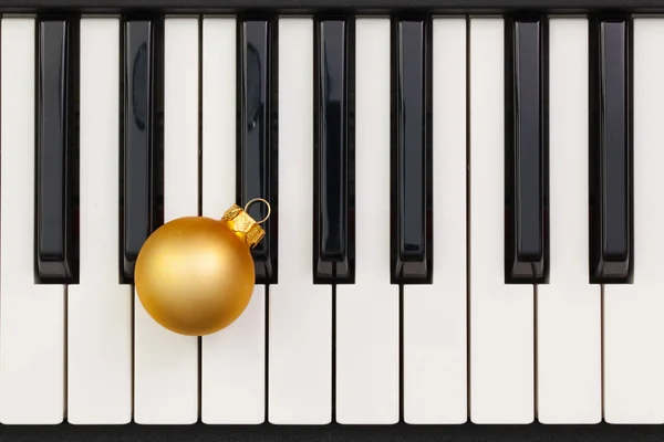 Top view close up shot of piano keyboard and Christmas decoratio