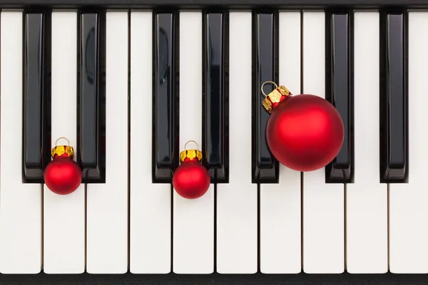 Top view close up shot of piano keyboard and Christmas decoratio