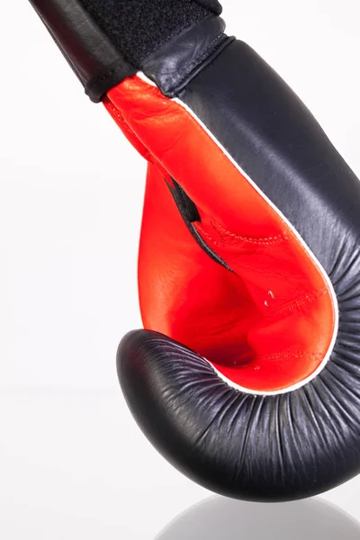 Red and black boxing gloves on a glass table — Stock Photo, Image