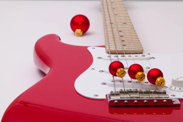 Red electric guitar and Christmas decoration — Stock Photo, Image