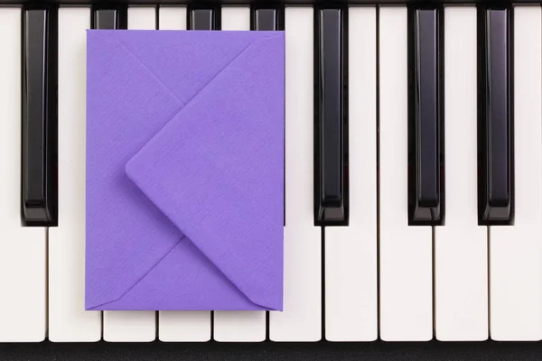 Envelope de arranjo engraçado nas teclas de piano — Fotografia de Stock