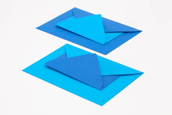 Jigsaw puzzle from big and small blue envelopes on the white tab — Stock Photo, Image