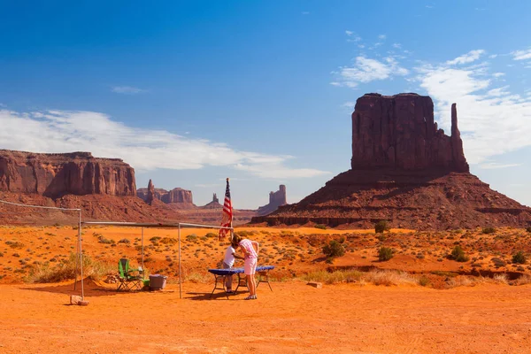 Monument Valley, Utah, USA - July 7,2011: Iconic peaks of rock formations in the Navajo Tribal Park of Monument Valley in Utah, USA. The park, frequently a filming location for Western movies, is accessed by the looping, 17-mile Valley Drive.