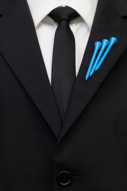 The detail of wedding suit with golf design. Blue golf tees on the flap of black jacket. clipart