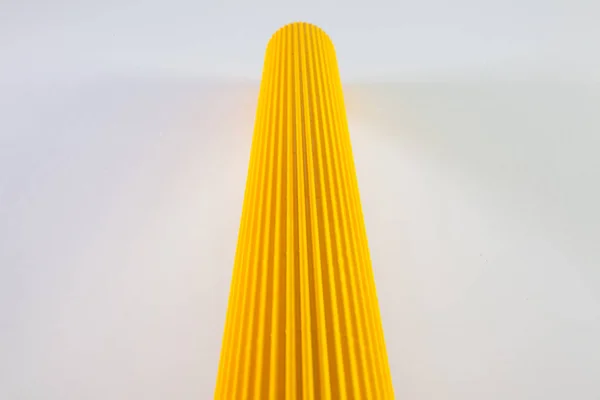 Corrugated yellow paper rolls on the white desk. — Stock Photo, Image