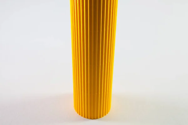 Corrugated yellow paper rolls on the white desk. — Stock Photo, Image