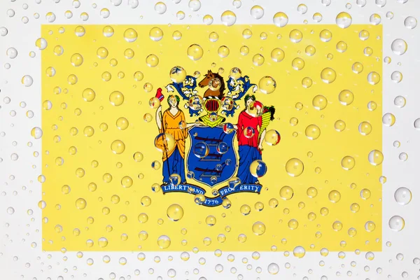 Bandeira de American State New Jersey atrás de um copo coberto com ra — Fotografia de Stock
