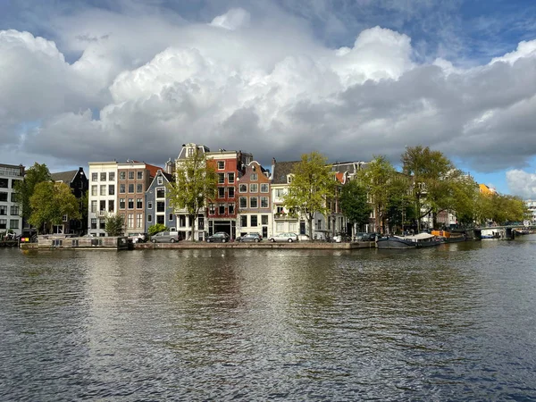 Canal de Amsterdã com casas típicas holandesas e casas flutuantes, barcos — Fotografia de Stock