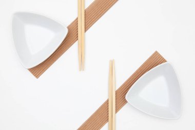 Beyaz boş suşi tabaklarının bambu çubuklarıyla üst görünümü. 
