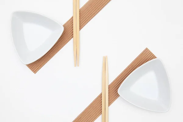 Top View Of White Empty Sushi Plates With Bamboo Chopsticks. — Stock Photo, Image