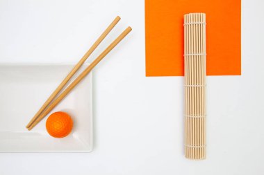 Top View Of White Empty Sushi Plates With Bamboo Chopsticks and Golf Ball. Golf  Design