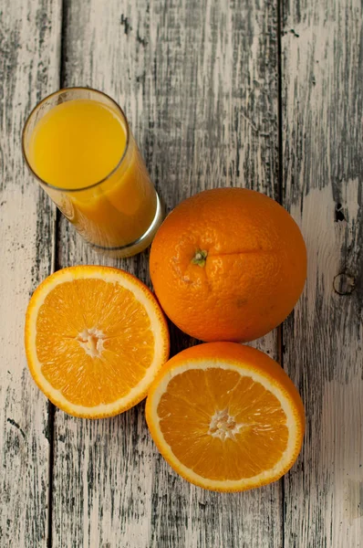 Orange fruit cut and orange juice on wooden table background,