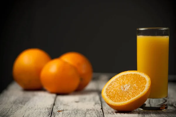 Orange fruit cut and orange juice on wooden table background, — Stock Photo, Image