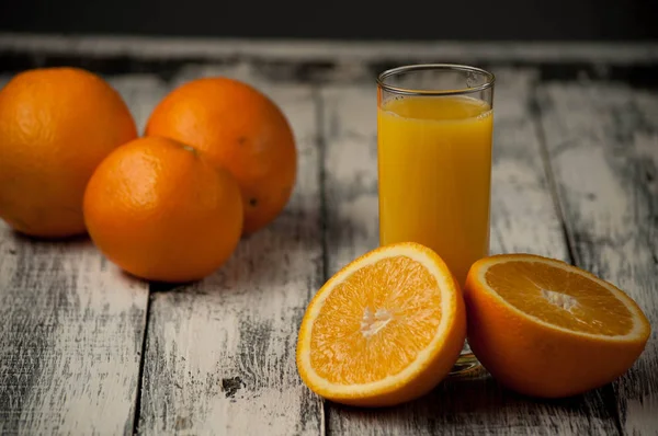 Orange fruit cut and orange juice on wooden table background, — Stock Photo, Image