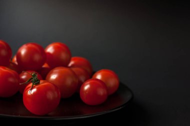 Siyah arkaplanda domatesler.