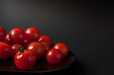 Siyah arkaplanda domatesler.