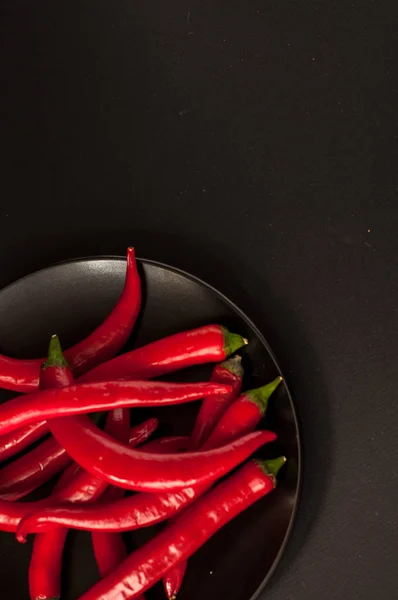 Chiles rojos sobre fondo negro — Foto de Stock