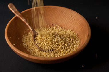 Koyu ahşap izole kahverengi ahşap kase kuru bulgur buğday