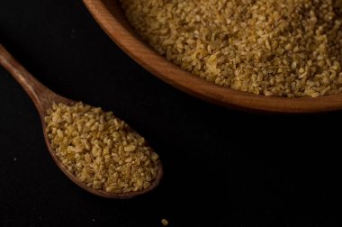 Koyu ahşap izole kahverengi ahşap kase kuru bulgur buğday