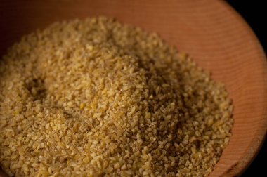 Koyu ahşap izole kahverengi ahşap kase kuru bulgur buğday