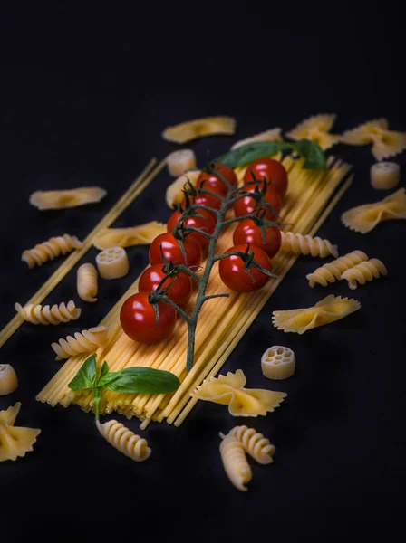 Raw pasta tomatoes and basil close up — Stock Photo, Image
