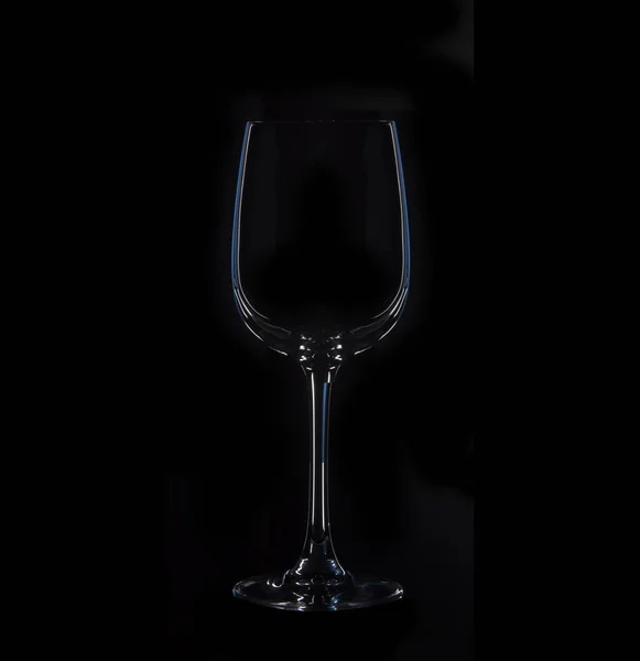 Silhouette of glass, isolated on black with blue illumination — Stock Photo, Image