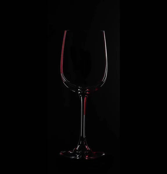 Silhouette of glass, isolated on black with red illumination — Stock Photo, Image