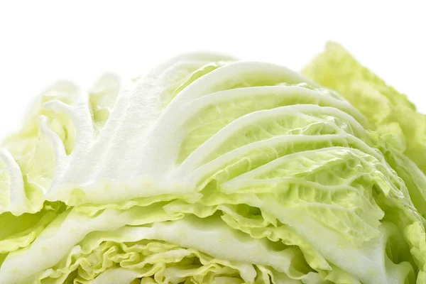 Macro shot of a surface of lettuce. Chinese cabbage on a white background. — Stockfoto