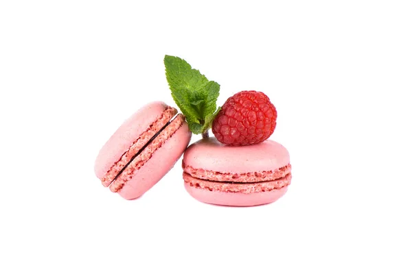 Two pink macaroon with raspberry and mint leaves isolated on a white background. — Stock Photo, Image