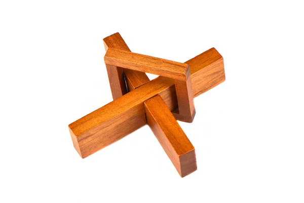 Trä kors pussel isolerad på en vit bakgrund. — Stockfoto