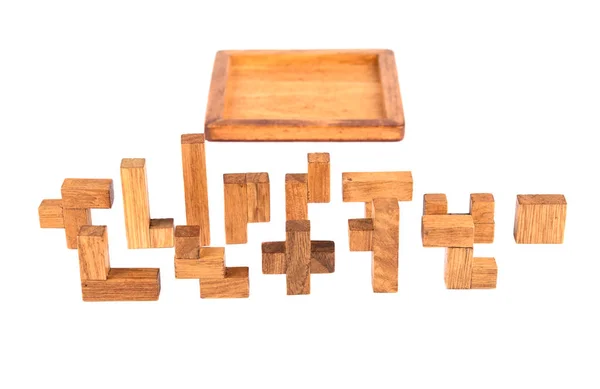 Details and box three-dimensional wooden pentamino board game on a white background. — Stock Photo, Image