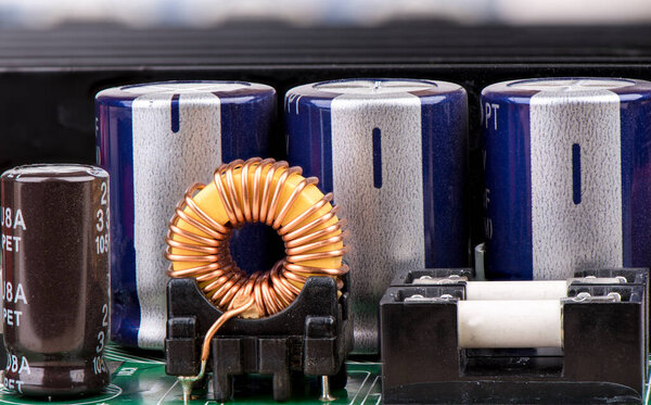 Yellow inductor, capacitors and fuses close up. 